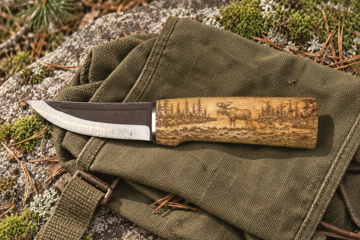 Roselli handmade Finnish Hunting Knife with a detailed Finnish moose engraving on the curly birch handle.