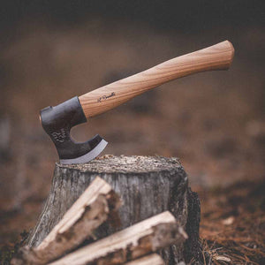 Picture of Roselli's handmade outdoor axe with a handle of red elm out in the woods.